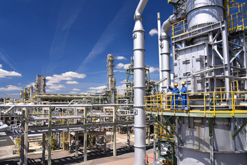 Industrial worker in a chemical factory - production of fuel in a refinery - buildings, facilities...