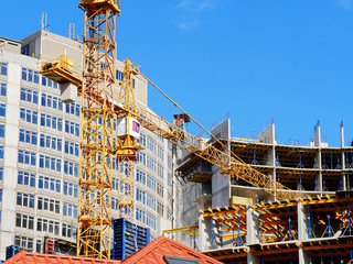 Construction site background.Cranes near concrete building.