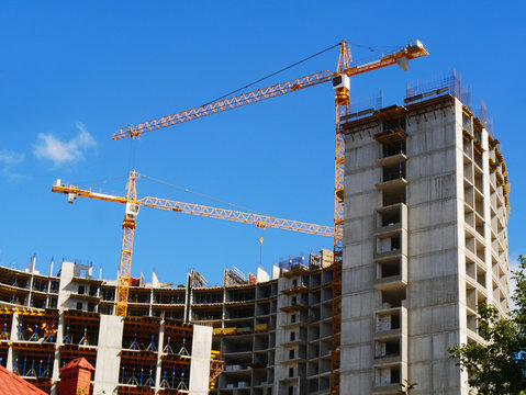 Construction site background. Two cranes near building. Commerxial building proiect.