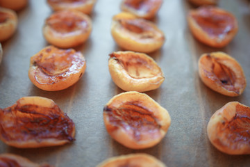 half apricot on baking paper on the grate