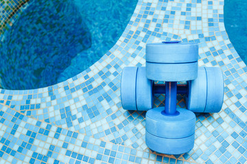 dumbbells equipment for aqua aerobics sport near swimming pool
