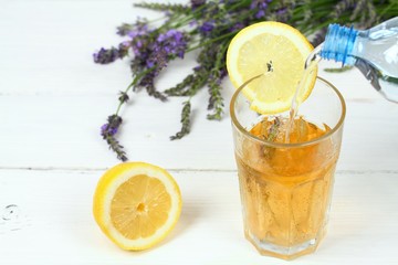 Making homemade lemonade / Pouring soda water into lavender syrup. Made from fresh aromatic lavender flowers, sugar or honey and lemon juice