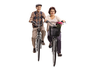 Obraz premium Elderly man and an elderly woman riding bicycles towards the camera