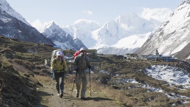 Two backpackers on the trekking Larke Pass in Nepal. Manaslu area.