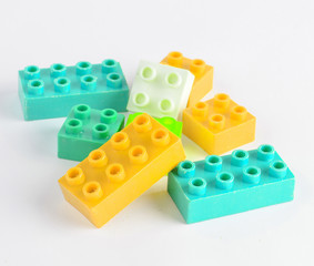 Colorful toy bricks of a children's designer on a white background..