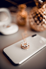 Stylish beautiful gold necklace on telephone