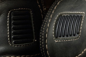 Natural dark brown leather with black rubber insert. Abstract background