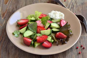 Strawberry salad with cucumber and  lettuce with yogurt sauce