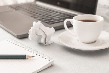 Workplace. Notebook, pencil, laptop, cup of coffee. Close up.  Business, education concept. Morning time