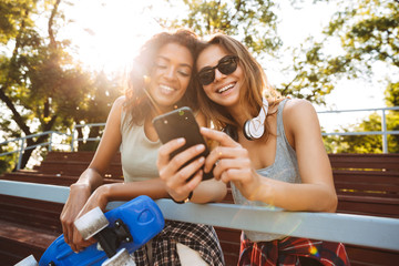 Two excited young girls with skateboard having fun © Drobot Dean