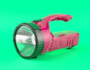 Blue flashlight isolated on a yellow background.