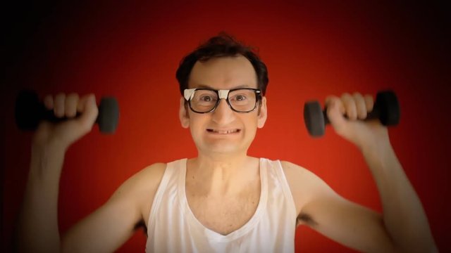 A funny ugly nerd man, exercising his arms with two weights, but slowly collapsing under the effort.
