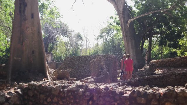 Beautiful blonde model walking trough the gede ruins in Africa (RedTech)(Slowmo)