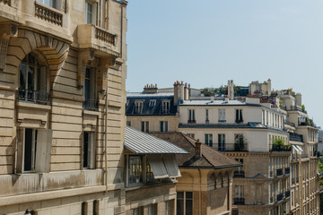 Paris residential buildings. Old Paris architecture, beautiful facades, typical french houses on sunny day. Famous travel destinations in Europe. City life, lifestyle and expensive real estate concept
