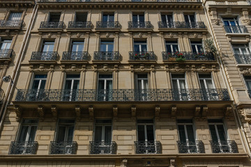 Fototapeta na wymiar Paris residential buildings. Old Paris architecture, beautiful facades, typical french houses. Famous travel destinations in Europe. Backgrounds. City life, lifestyle and expensive real estate concept