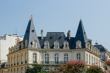 Paris residential buildings. Old Paris architecture, beautiful facades, typical french houses on sunny day. Famous travel destinations in Europe. City life, lifestyle and expensive real estate concept