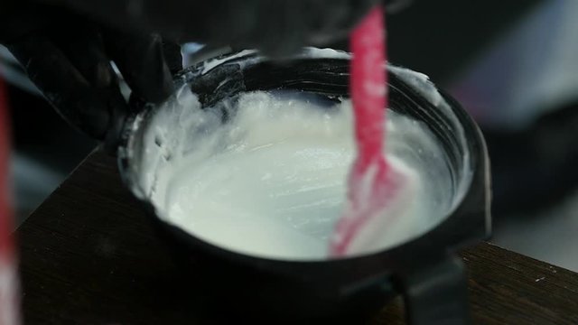 process of mixing of components for reception without an aldehyde paint in a beauty salon. slow motion
