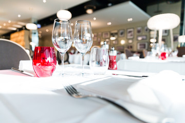 Brightly Lit Red and White Restaurant Table Glasses with Blurred Background
