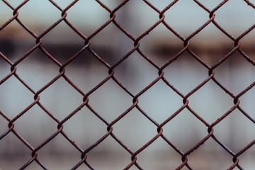 Metal mesh. Rusty mesh. The texture of the rusty mesh. Natural mesh in the village.