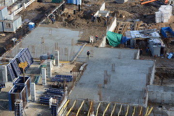 Workers at the construction site, building high-rise buildings.