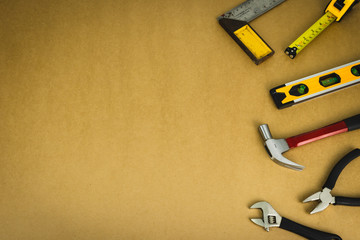 Mechanic tools set on brown background.