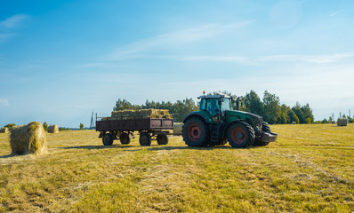 tractor on the field with hay