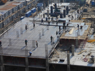 Workers at the construction site, building high-rise buildings.