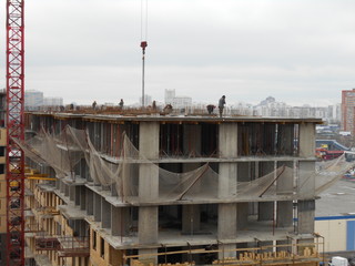 Workers at the construction site, building high-rise buildings.
