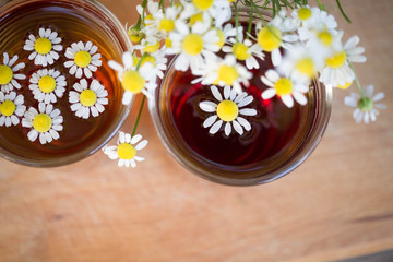 chamomile tea in a cup. tea with chamomile in a glass on a wooden background