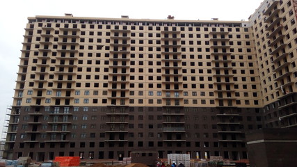 Construction of a multi-apartment residential building. The process of construction. Stages of construction.