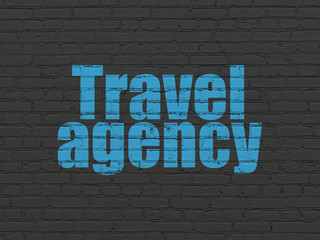 Tourism concept: Painted blue text Travel Agency on Black Brick wall background