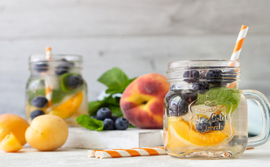 Lemonade of  apricot, blueberry and fresh mint in jars. Summer cold drink.