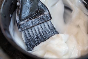Background of Barber supplies, applying color cream at hair in salon.