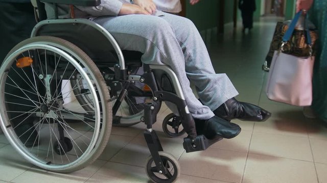 Disabled man on a wheelchair standing inside hospital or university