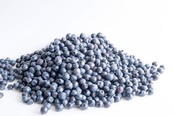 Blueberries on a white background close up, soft focus. Summer wild berry
