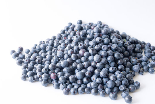 Blueberries on a white background close up, soft focus. Summer wild berry