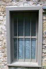 A window frame on the building and on a close view.