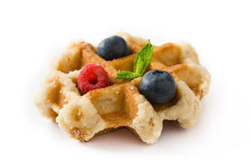 Traditional belgian waffles with blueberries and raspberries isolated on white background. Close up