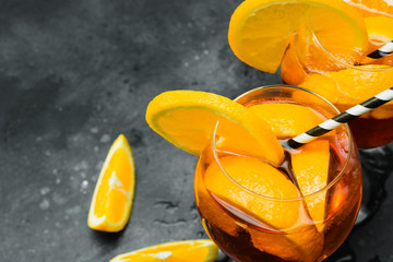 Classic aperol spritz cocktail in glass on dark. View from above and close up.
