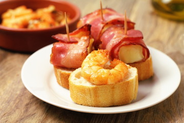 Tapas with bacon, cheese and shrimp