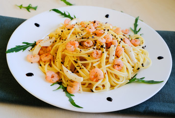 Pasta with prawns and squid meat on a white plate