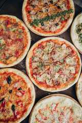 italian pizzas in a black concrete background. Copyspace Top view Banner