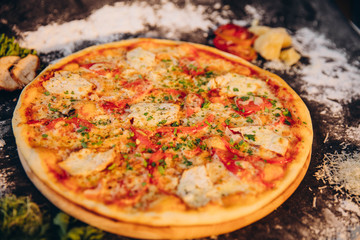 Food ingredients and spices for cooking  delicious italian pizza in a black concrete background. Copyspace Top view Banner.