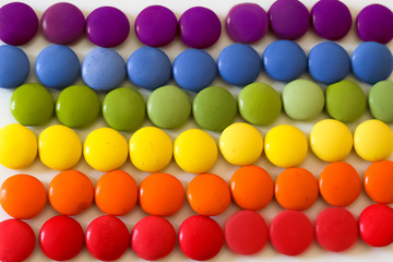 Fototapeta na wymiar rainbow with colorful chocolates background