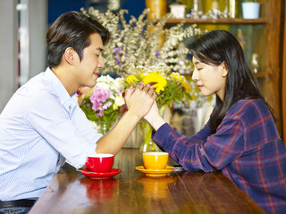 young asian couple making a wish