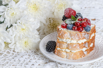 Homemade cake with ricotta and fresh berries-raspberries, red currants, blueberries and blackberries with mint and powdered sugar