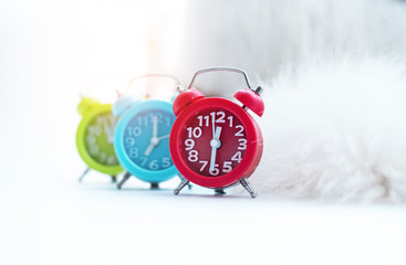 The red alarm clock put on background,blurry light design background