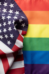 American stars and stripes flag alongside a gay Pride LGBT rainbow flag