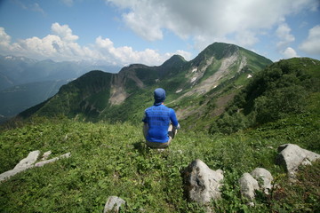 Tourist admires the mountains of the Caucasus