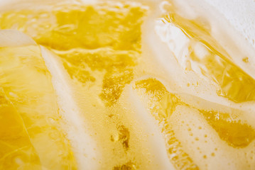Pouring beer with bubble froth in glass for background.